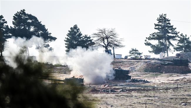 Tanks of the Turkish army shoot in the direction of Syria near the Syrian border in Kilis south central Turkey