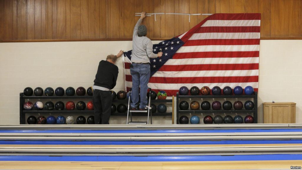 Workers take down a U.S. flag following a campaign stop by Democratic presidential candidate Hillary Clinton at the Family Fun Center in Adel Iowa Jan. 27 2016