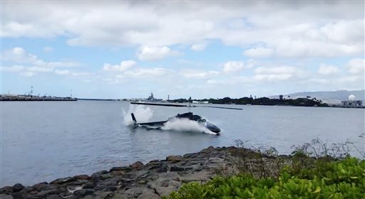 In this image taken from video provided by Shawn Winrich a helicopter crashes near Parl Harbor Hawaii on Thursday Feb. 18 2016. The private helicopter with five people aboard crashed and sunk into the water leaving a teenage passenger in critical con