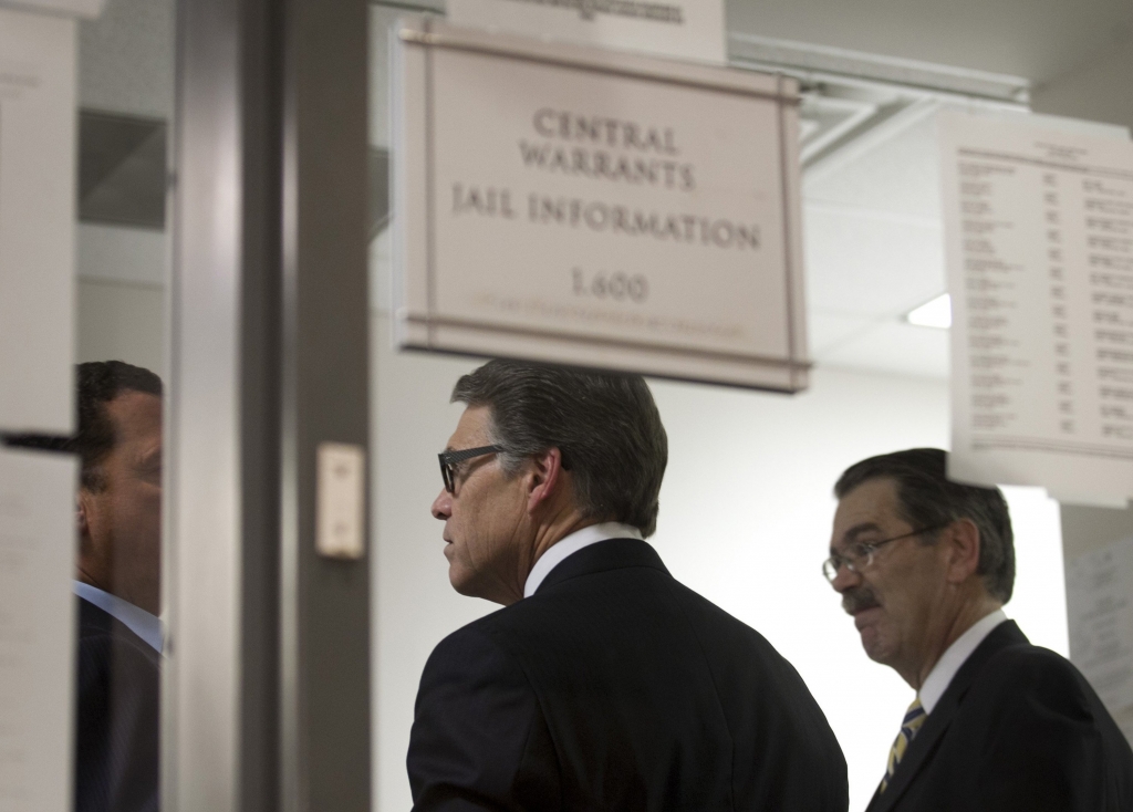 Texas Gov. Rick Perry middle is booked at the Blackwell Thurman Criminal Justice Center in Austin Texas for two felony indictments of abuse of power on Tuesday