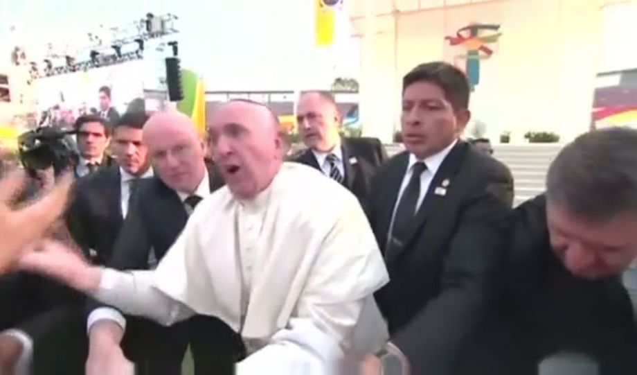 Pope Francis reacts to a man in Mexico pulling on his robe Feb. 16 2016 which causes him to almost tumble into a man in