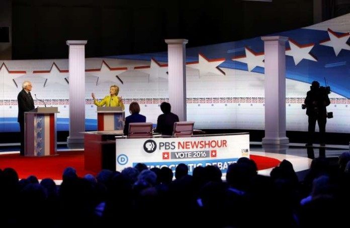 Democratic presidential candidates Sen. Bernie Sanders and Hillary Clinton take the stage before a Democratic presidential primary debate at the University of Wisconsin Milwaukee on Thursday