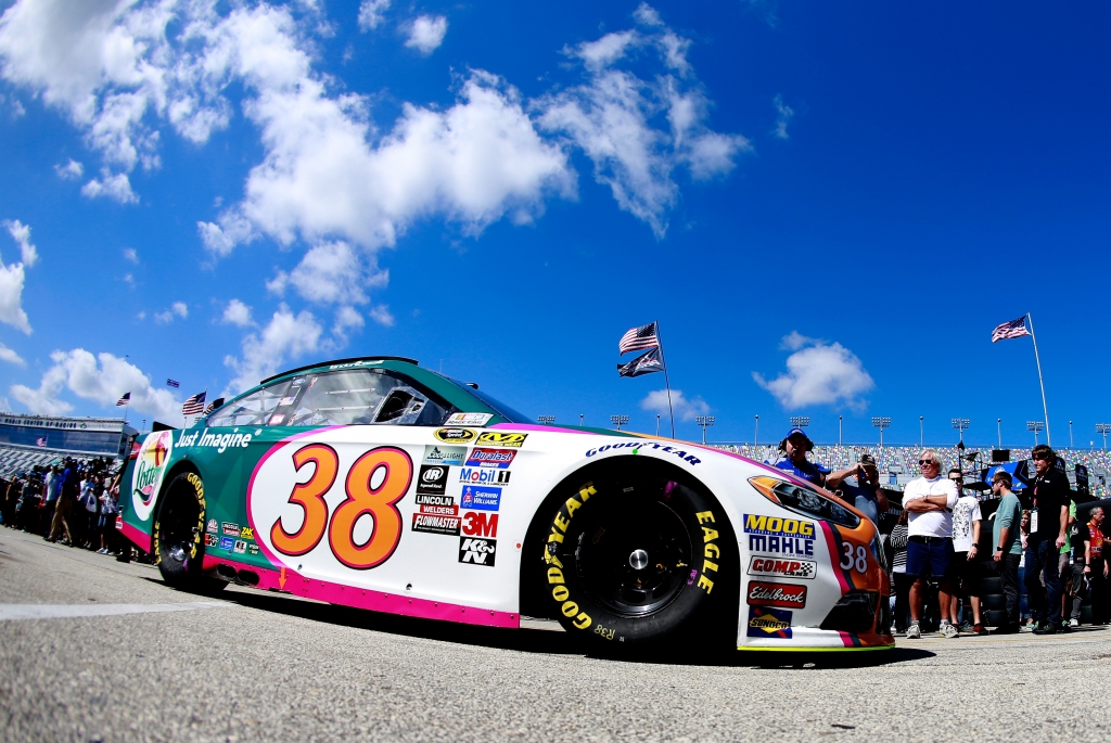 DAYTONA BEACH FL- FEBRUARY 20 Landon Cassill driver of the #38 Florida Lottery Ford drives through the garage area during practice for the NASCAR Sprint Cup Series Daytona 500 at Daytona International Speedway