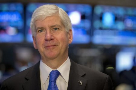 Michigan Governor Rick Snyder gives an interview on the floor of the New York Stock Exchange