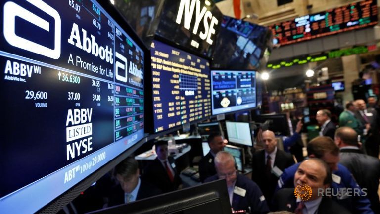 Traders gather at the booth that trades Abbott Laboratories on the floor of the New York Stock Exchange