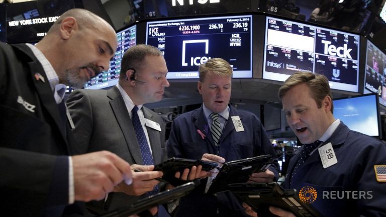 Traders work with a floor official on the floor of the New York Stock Exchange