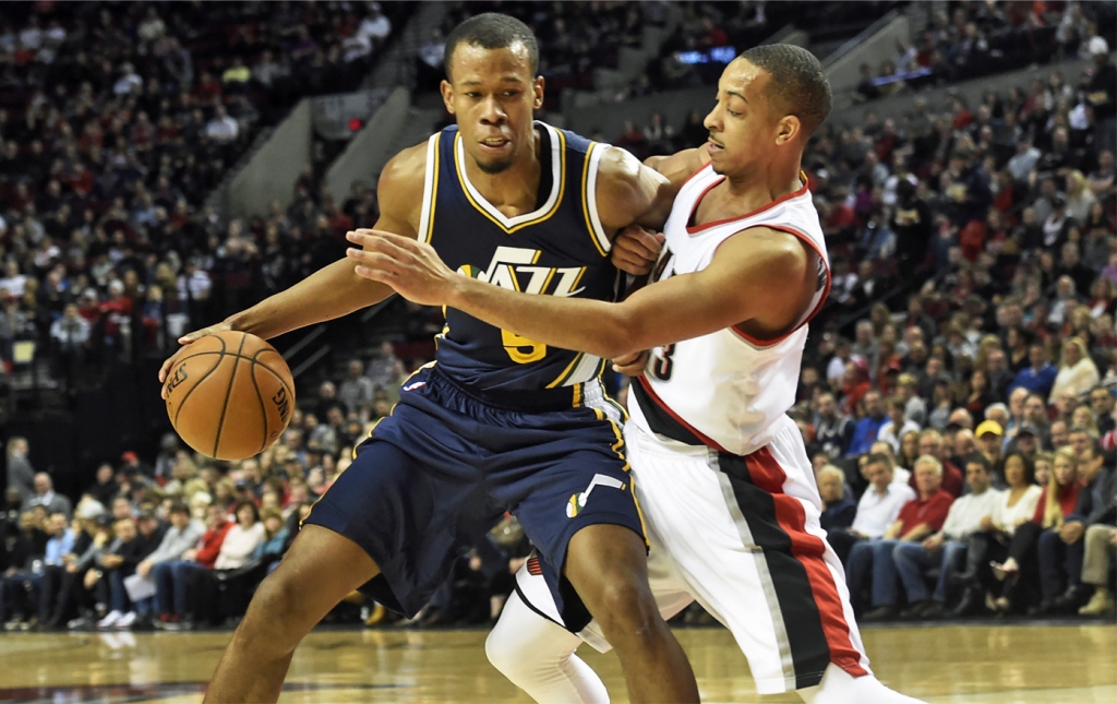 Utah Jazz guard Rodney Hood tries to get around Portland Trail Blazers guard C.J. Mc Collum during the first half of an NBA basketball game in Portland Ore. Sunday Feb. 21 2016