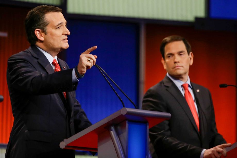 Republican presidential candidate Sen. Ted Cruz R-Texas answers a question as Sen. Marco Rubio R-Fla. looks on during a Republican presidential primary debate Thursday Jan. 28 2016 in Des Moines Iowa