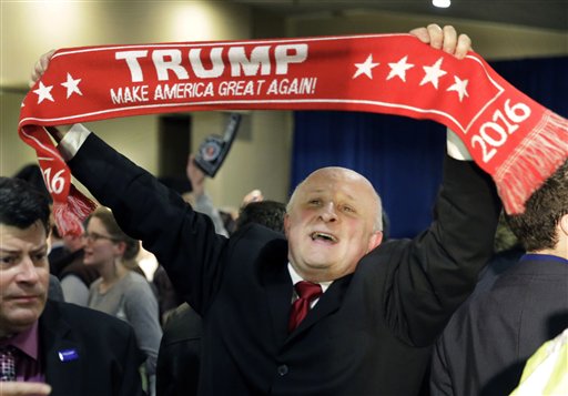 A supporter holds a sign touting Republican presidential candidate businessman Donald Trump during a primary night rally Tuesday Feb. 9 2016 in Manchester N.H