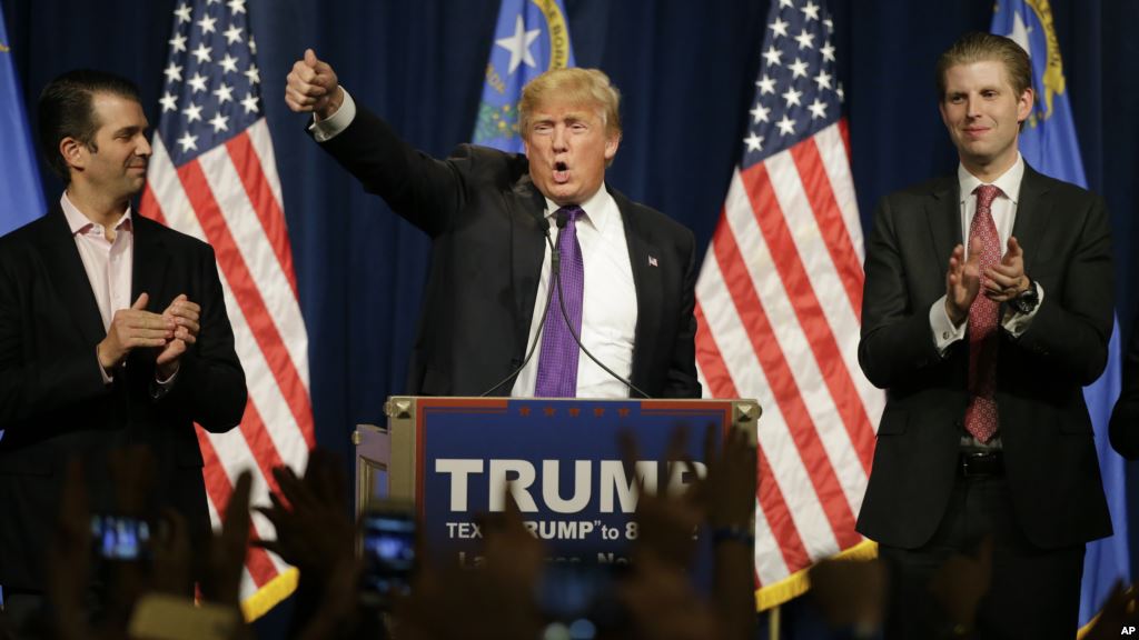 Republican presidential candidate Donald Trump is flanked by his two sons Donald Trump Jr. left and Eric while speaking at a caucus night rally Tuesday Feb. 23 2016