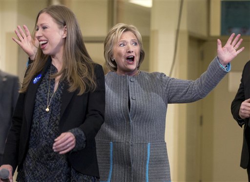 Democratic presidential candidate Hillary Clinton accompanied by her daughter Chelsea Clinton reacts to applause as she arrives for a rally at Abraham Lincoln High School in Council Bluffs Iowa Sunday Jan. 31 2016