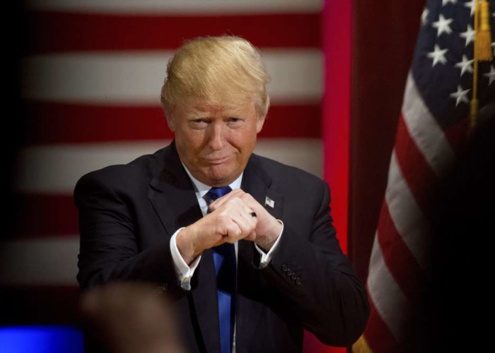 Republican presidential candidate Donald Trump poses with a ring given to him by a group of veterans during a campaign event on the campus of Drake University Thursday Jan. 28 2016 in Des Moines Iowa. AP