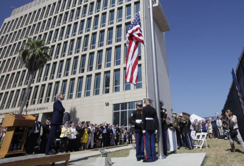 U.S. Secretary of State John Kerry watches the raising of the American flag at the newly opened U.S. Embassy in Havana Cuba on Aug. 14 2015