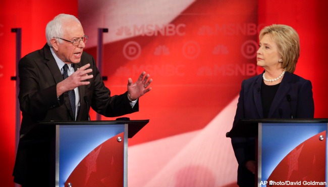 Democratic presidential candidate Hillary Clinton listens as Democratic presidential candidate Sen. Bernie Sanders I-Vt answers a question during a Democratic presidential primary debate hosted by MSNBC at the University of New Hampshire Thursday Fe