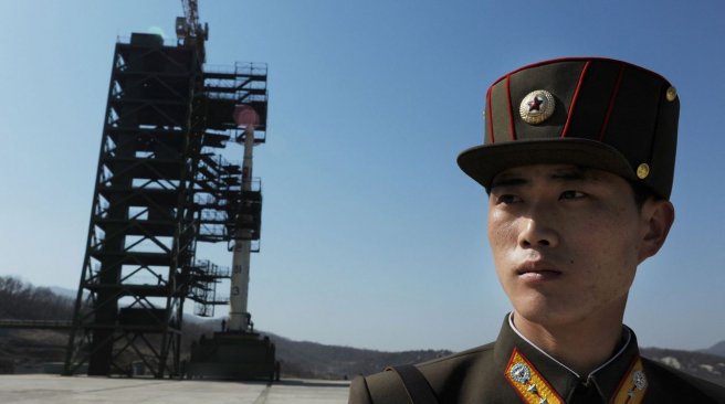 8 2012 shows a North Korean soldier standing guard in front of an Unha-3 rocket at the Sohae Satellite Launch Station in Tongchang-Ri. AFP