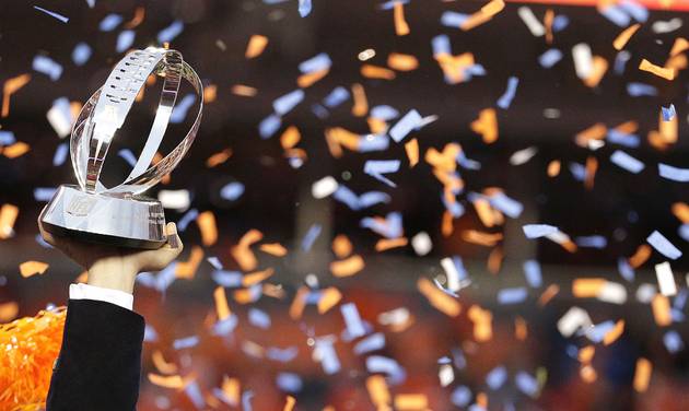 Denver Broncos general manager and executive vice president of football operations John Elway left is flanked by head coach Gary Kubiak as he holds the AFC Championship trophy following the NFL football AFC Championship game between the Denver Broncos