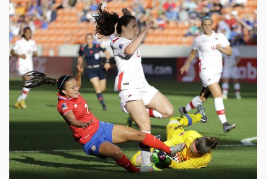 Canada goalkeeper Erin McLeod right grabs the ball as Allysha Chapman avoids her as Costa Rica's Melissa Herrera tries for the loose ball during first-half action Friday. McLeod's save was a key moment in the Canadian victory