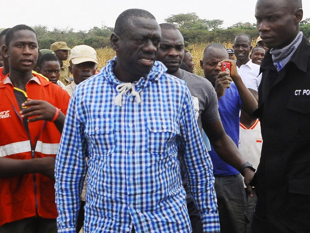 Uganda's Opposition leader Kizza Besigye center meets his supporters after casting his vote at a polling station near his country home in Rukungiri about 700 kilometres west of Kampala