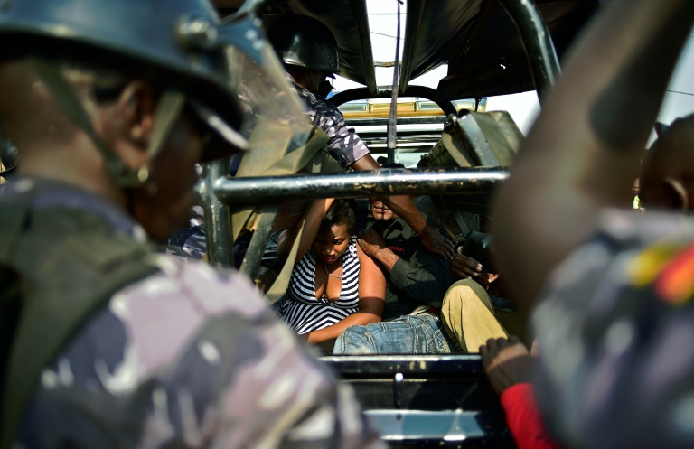 AFP  Carl de Souza People suspected of being involved in protests sit in the back of a vehicle after being arrested by police in Kampala