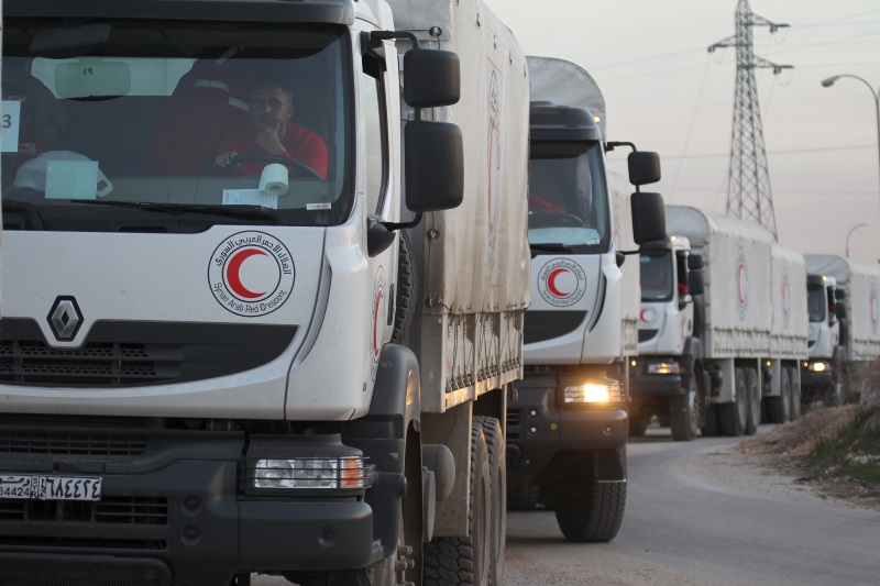 A Syrian Arab Red Crescent aid convoy heads towards the villages of al Foua and Kefraya in Idlib province