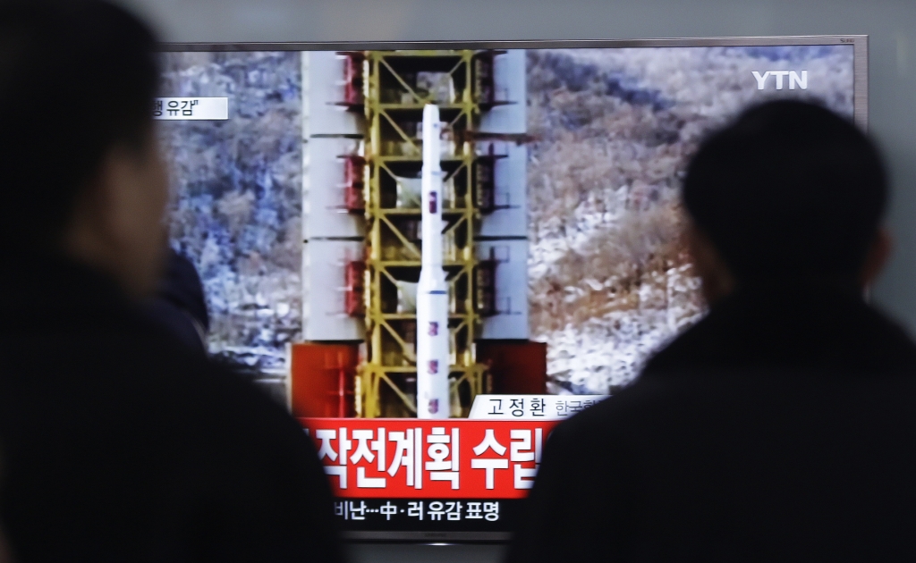 People watch a TV news reporting a rocket launch in North Korea at Seoul Railway Station in Seoul Sunday Feb. 7 2016. For North Korea's propaganda machine the long-range rocket launch Sunday carved a glorious trail of'fascinating vapor through the