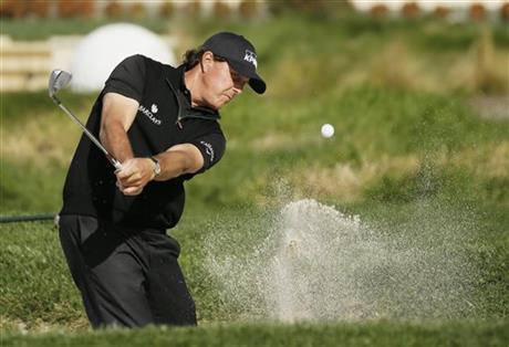 Phil Mickelson hits out of a bunker onto the second green of the Pebble Beach Golf Links during the final round of the AT&T Pebble Beach National Pro Am golf tournament Sunday Feb. 14 2016 in Pebble Beach Calif