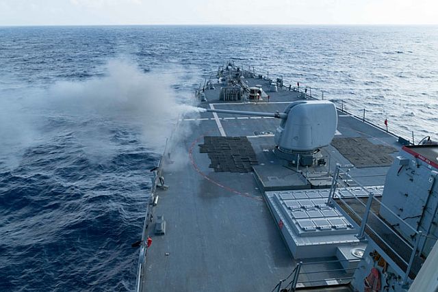 The Arleigh Burke-class guided-missile destroyer USS Curtis Wilbur conducts a live fire gunnery exercise in the South China Sea in this Feb. 15