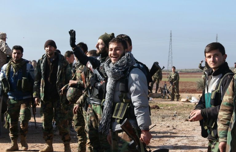 Syrians pro-government forces celebrate after they broke an opposition siege in the northern Shiite town of Zahraa