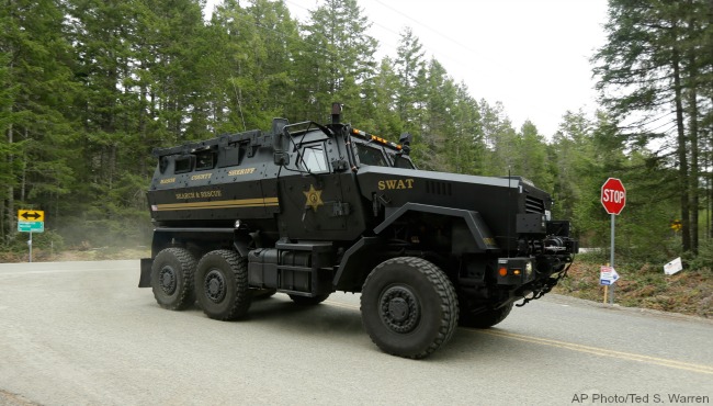 A Mason County Sheriff Dept. SWAT vehicle drives a few miles from the scene of a fatal shooting Friday Feb. 26 2016 near Belfair Wash