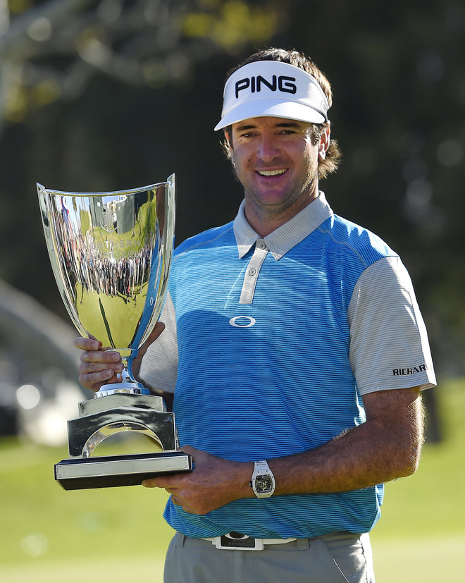 Bubba Watson holds up his trophy after winning the Northern Trust Open golf tournament Sunday Feb. 21 2016 in the Pacific Palisades section of Los Angeles