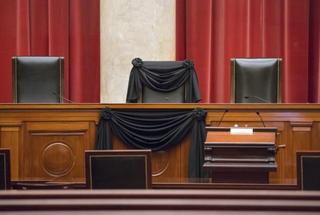 Supreme Court Justice Antonin Scalia’s courtroom chair is draped in black to mark his death as part of a tradition that dates to the 19th century