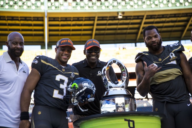 Pro Bowl participants Jerry Rice Russell Wilson Michael Irvin and Michael Bennett pose with the Pro Bowl Trophy after Team Irvin defeated Team Rice 49–27