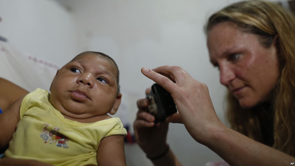 Henrique who was born with microcephaly after examining him in Joao Pessoa Brazil Tuesday Feb. 23 2016. In