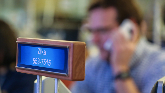 John Brook medical epidemiologist works the phone at his Zika station in the emergency operations center on Wednesday