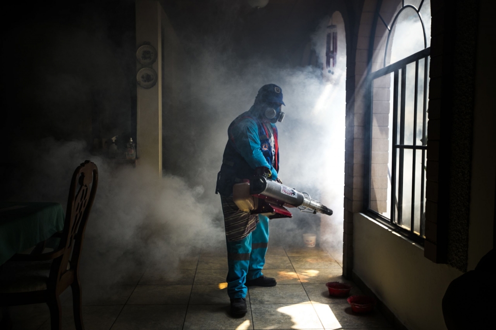 A worker fumigates a home for mosquitoes in San Salvador the capital of El Salvador