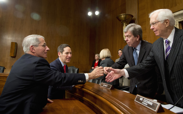 NIH National Institute of Allergy and Infectious Diseases Director Anthony Fauci left and CDC Director Thomas Frieden second from left shake hands with S