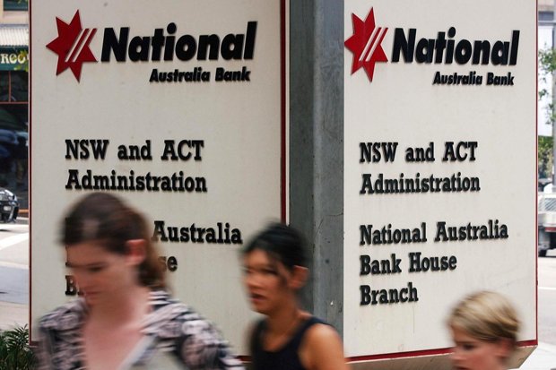 Pedestrians pass by offices of the National Australia Bank in Sydney