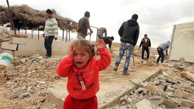 A Palestinian child cries as Palestinians salvage items from their home after it was demolished by Israeli bulldozers in the area of Musafir Jenbah south of the occupied West Bank city of al Khalil