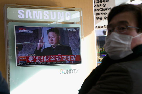 A commuter watches a television screen showing a breaking news on North Korea's long-range rocket launch at Seoul Station on Feb. 7 in Seoul