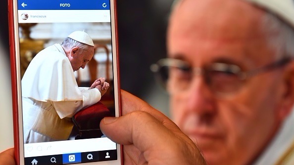 A man looks at the Instagram account of Pope Francis