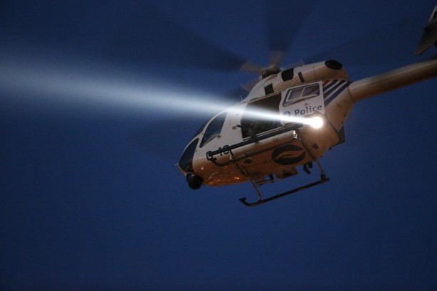 A police helicopter hovers over Brussels rooftops following bomb attacks in Brussels Belgium