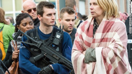 A police officer stands guard as people are evacuated from Brussels Airport on Tuesday morning