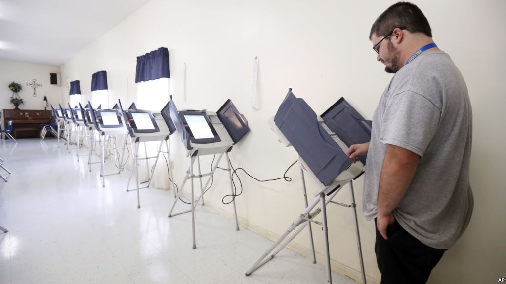 A voter casts his ballot in a polling booth in Canton as Mississippi holds its presidential and congressional primaries