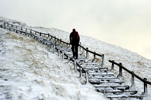 A walker makes their way through overnight snow in Buxton Derbyshire