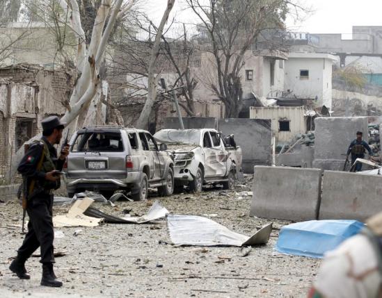 Afghan policemen take position during the gunfire in front of the Indian consulate in Jalalabad Afghanistan