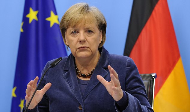 German Chancellor Angela Merkel gestures as she speaks during a press conference held at the end of a Eurozone summit at the Justus Lipsius building EU headquarters in Brussels