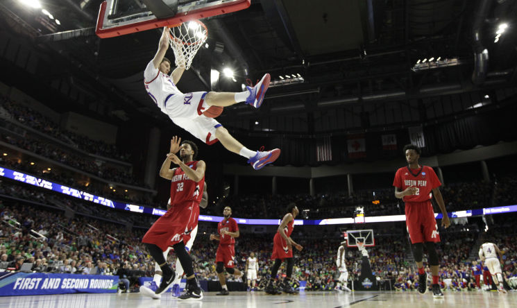 AIRING IT OUT Kansas guard Svi Mykhailiuk dunks for two of his career-high 23 points in the top seed’s win over Austin Peay