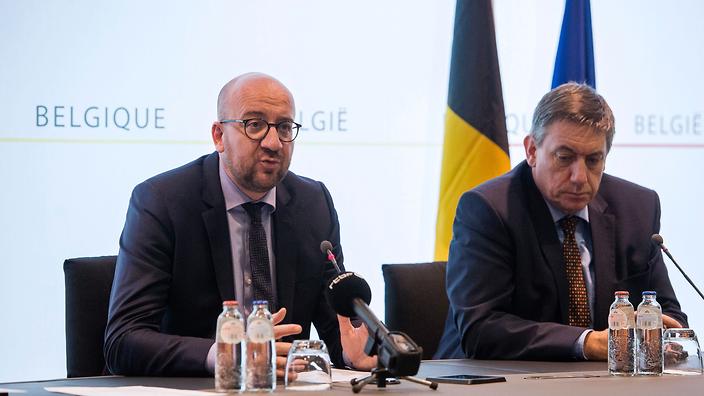 Belgian Prime Minister Charles Michel speaks as Interior and Minister Jan Jambon listens at a press conference on March 15