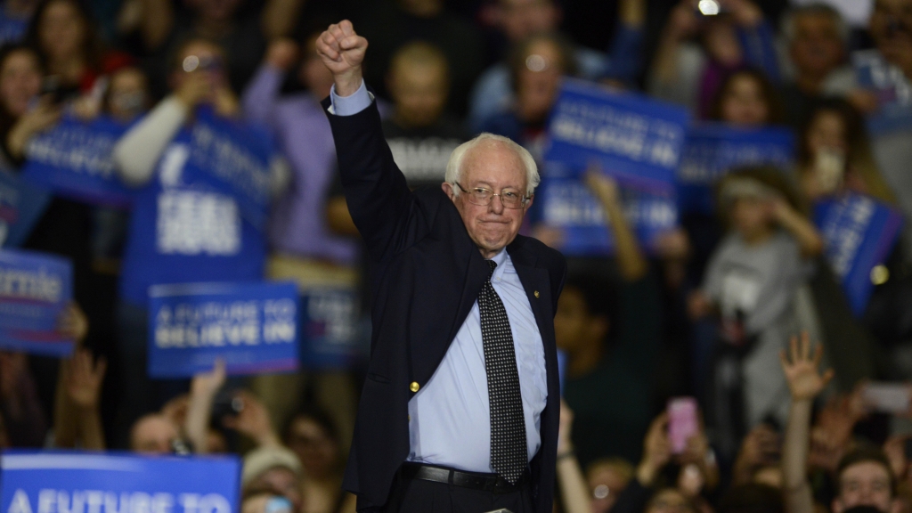 Bernie Sanders waves as he leaves the stage at a rally in Illinois