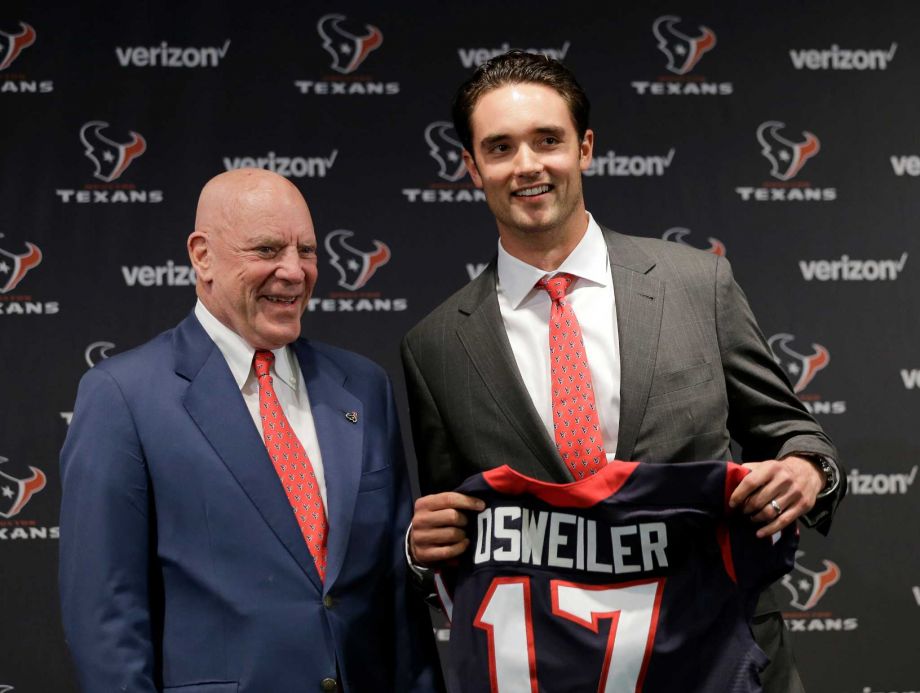 Houston Texans quarterback Brock Osweiler right holds his new jersey as he poses with owner Bob Mc Nair during a news conference Thursday